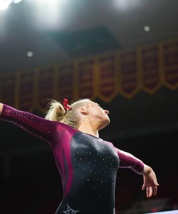 Image of teenage girl with blonde hair doing gymnastics pose