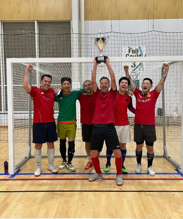 Men's futsal team in front of goals